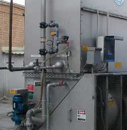Shown mounted on the circulation piping of an evaporative cooling tower. The system is complete with a Total Dissolved Solids detection unit to control the basic chemistry of the water in the tower.